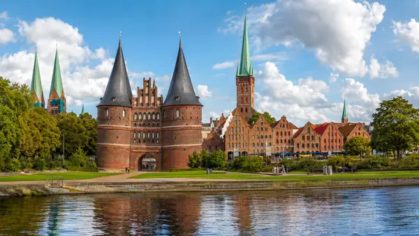 KI-generierte Stadtansicht mit typischen Merkmalen von Lübeck – Altstadt mit Holstentor und Türmen
